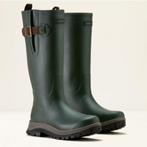 Pair of green rubber boots with a brown strap on a light beige background